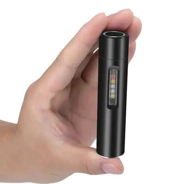 Black portable boruit rechargeable flashlight with LED lights held in a hand.