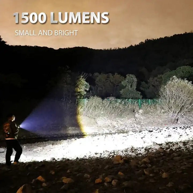Person using a Peetpen P11500 lumens EDC flashlight illuminating a dark outdoor area